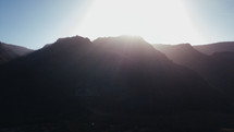 sunlight behind mountains 