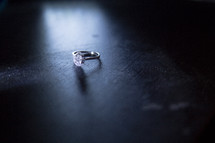 diamond ring on a wood table 