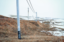 Winter field with power line columns