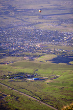 hot air balloon over a green valley 