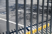 Fence and shadow in a parking lot
