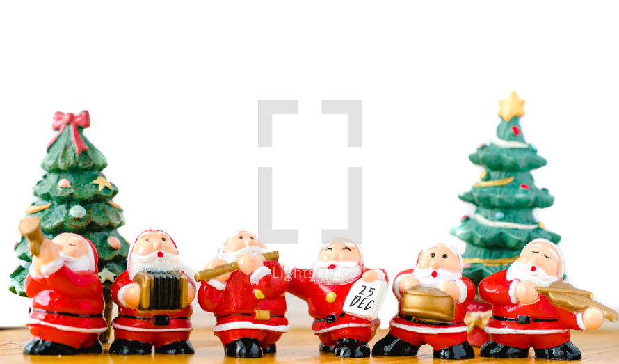 Santa Claus figurines against a white background 