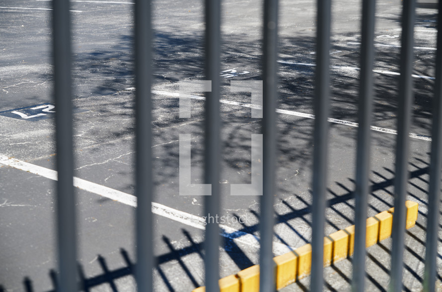 Fence and shadow in a parking lot