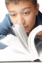a boy reading an interesting book 