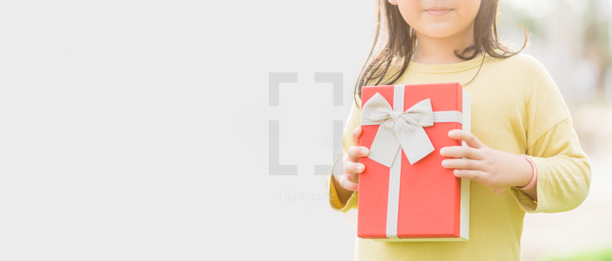 arms holding a red Christmas gift 