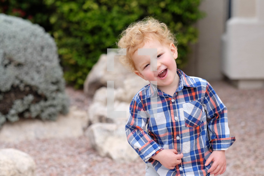 happy toddler in a plaid shirt 