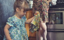 toddler girl cleaning with a rag 