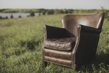 a leather chair in a field 