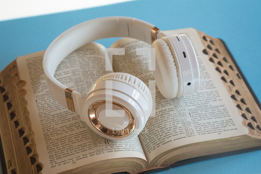 headphones on the pages of a Bible 