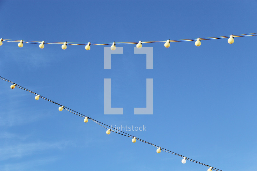 string of lights against a blue sky 