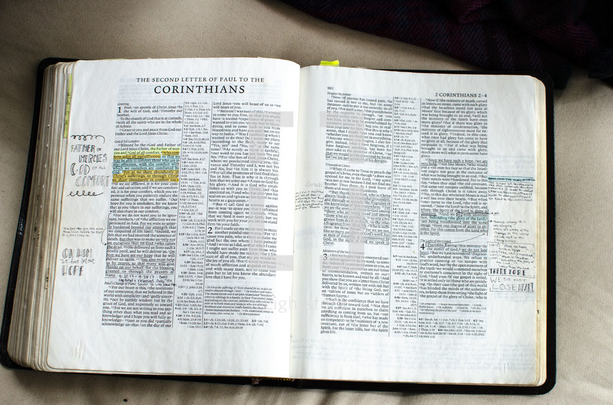 handwritten notes on pages of a Bible opened to Corinthians