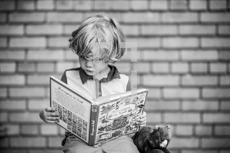 a child reading a book at school 