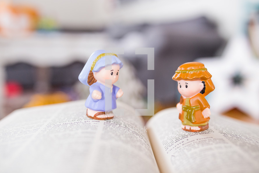 toy manger Biblical figures on the pages of a Bible 