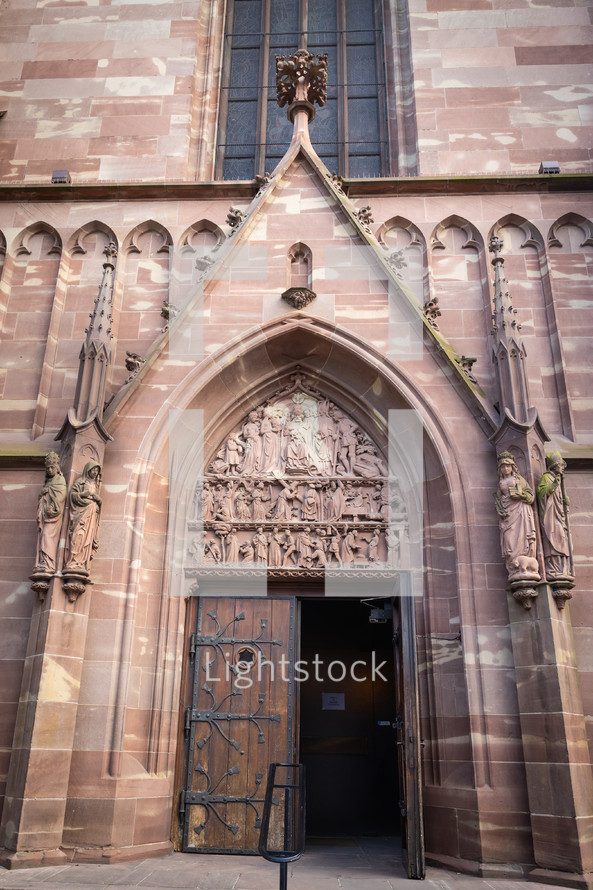 Door in stone Cathedral with statues