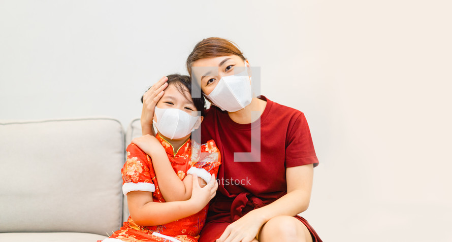 mother and child wearing face masks 