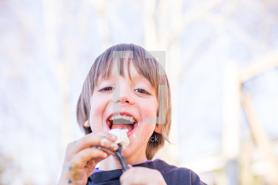 a child eating roasted marshmallows 