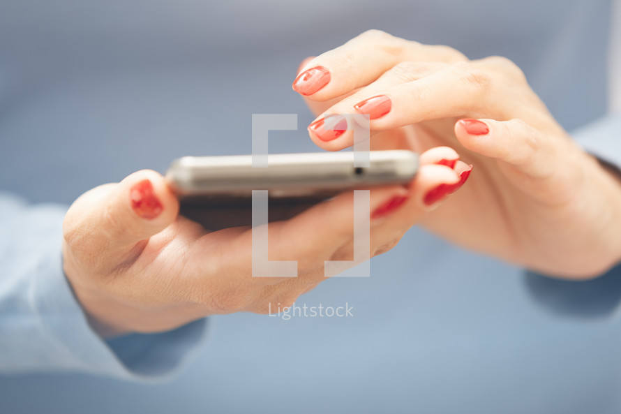 a woman scrolling through a cellphone 