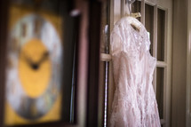 bridal gown hanging on a door 