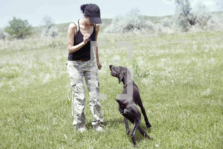 a woman training her dog 