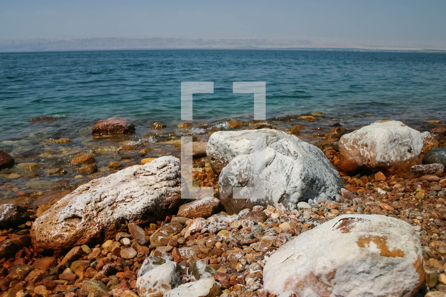 Rocks covered in salt on the shore of the Dead Sea