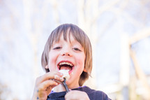 a child eating roasted marshmallows 