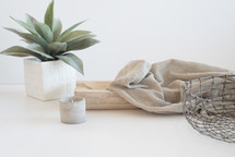 wire basket, house plant, linen fabric, and votive 