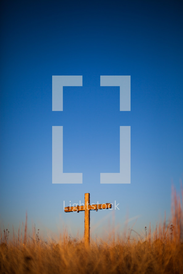 Cross on a hill at sunrise.