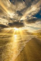 rays of sunlight shining onto a beach 