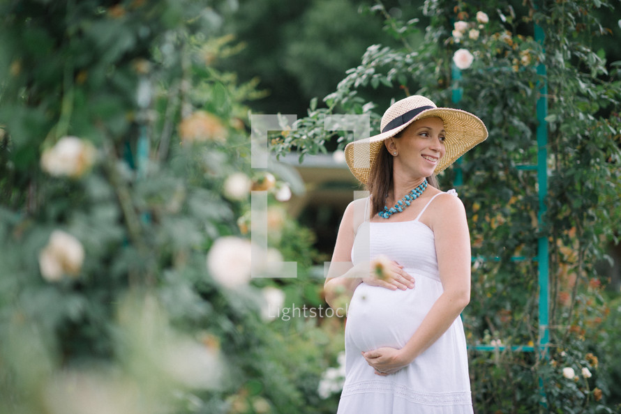 pregnant woman in a straw hat 
