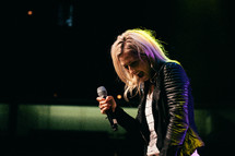 teen girl on stage with a microphone 