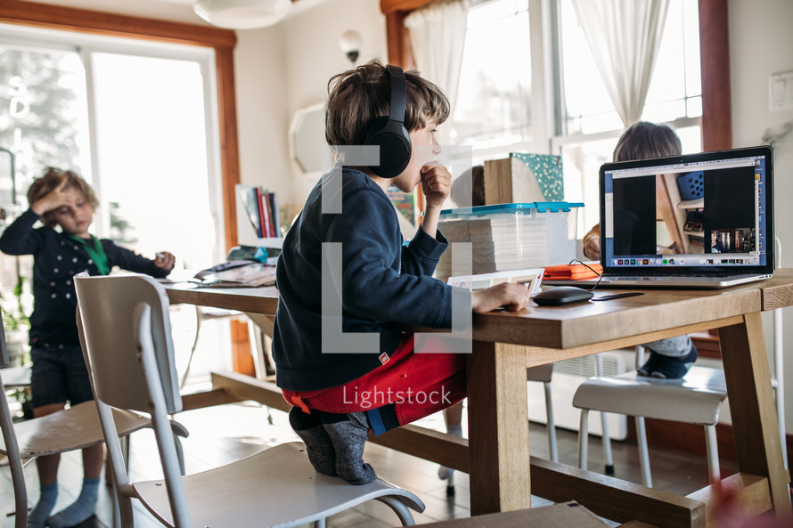 children doing a video conference in a kitchen 