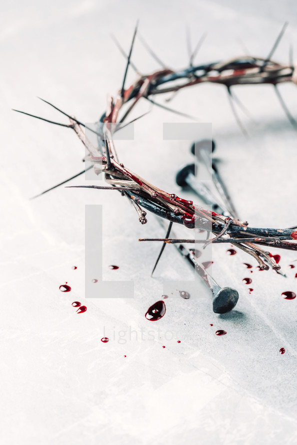Crown of thorns with blood dripping, nails on stone. Christian concept of Jesus Christ suffering, passion. Good Friday, Easter holiday. Copy space. Crucifixion, resurrection, gospel, salvation
