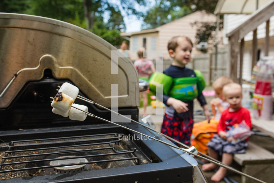 roasting marshmallows over a grill 