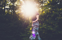 sunburst and a woman walking outdoors 