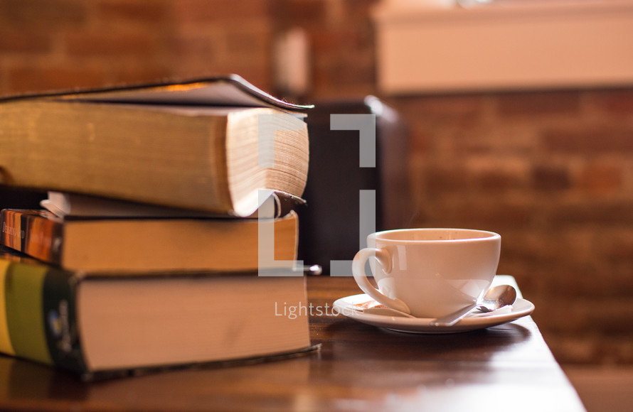 stack of books and a coffee cup 