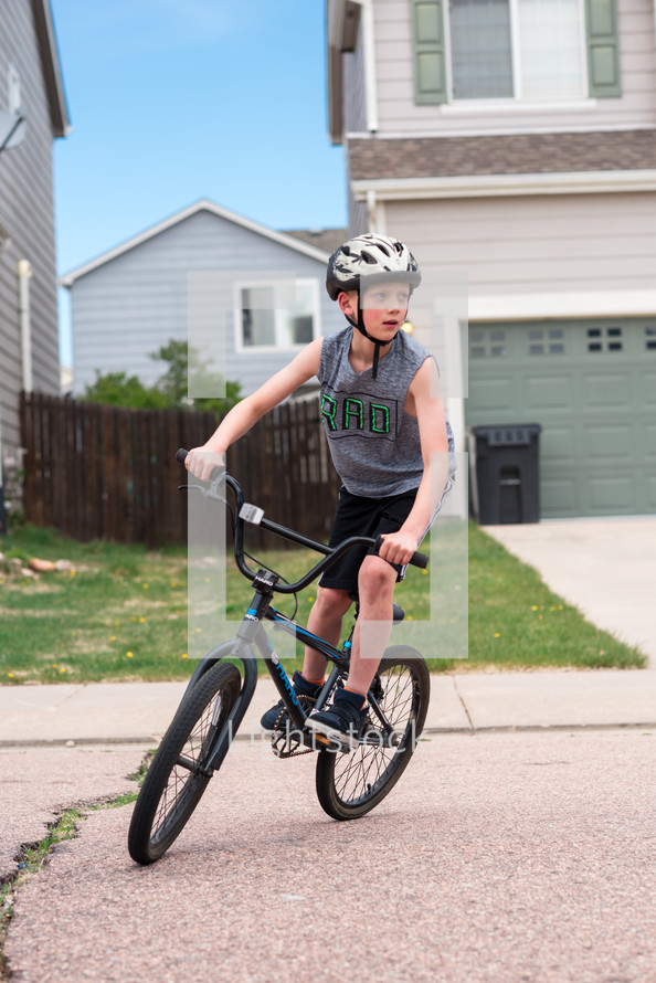 a boy riding a bike 