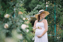 pregnant woman in a straw hat 
