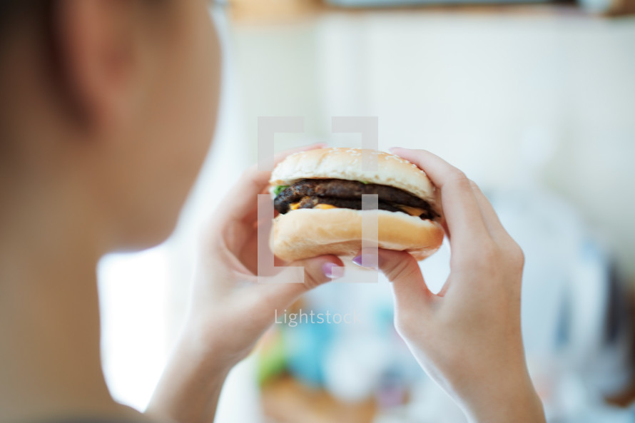 woman eating a hamburger 
