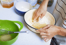 mixing batter with hands 