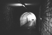 people walking through a tunnel 