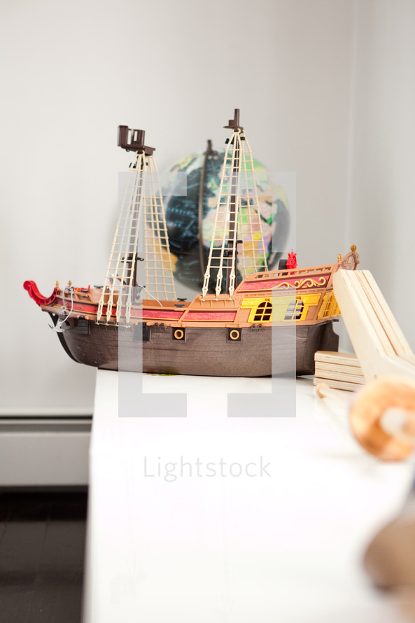toy ship on a bookshelf 