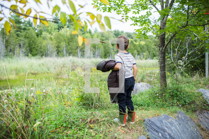 a boy exploring outdoors 