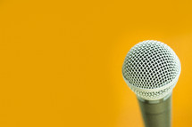 microphone against a yellow background 