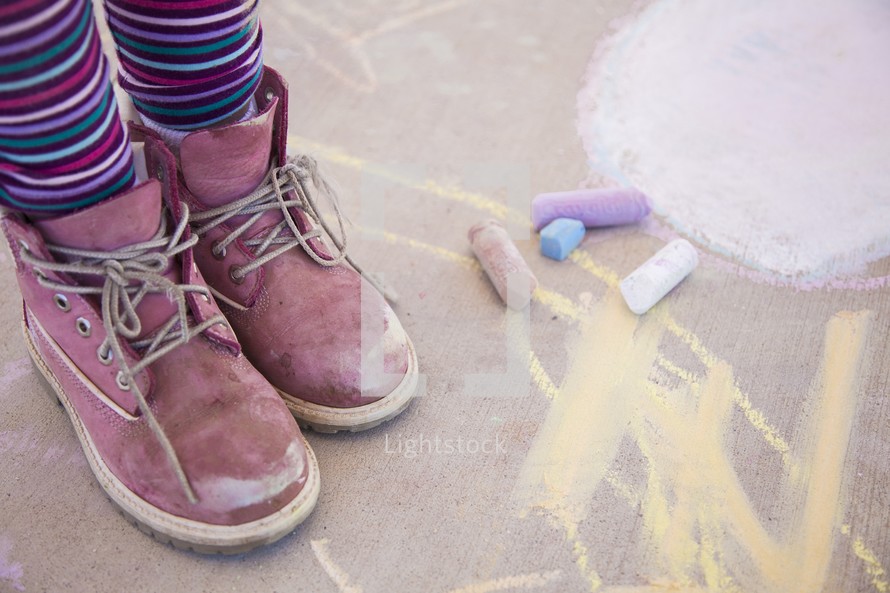 child and sidewalk chalk 
