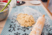 a rolling pin and cookie dough 