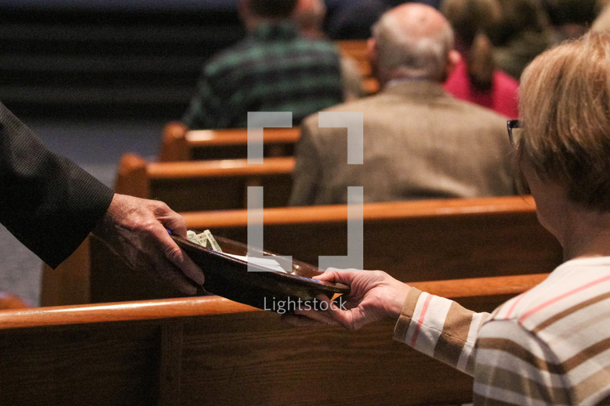 passing a collection tray during a church service 