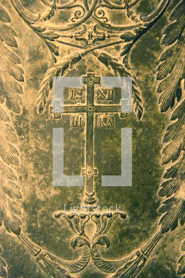 Bronze plaque with cross of Jesus and inscription in Greek.