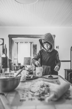 a boy in the kitchen and baking supplies 