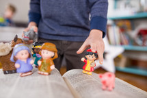 toy manger Biblical figures on the pages of a Bible 