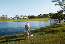woman standing at the edge of a lake in Florida 